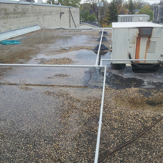 Existing asphalt and felt roofing system before repair
