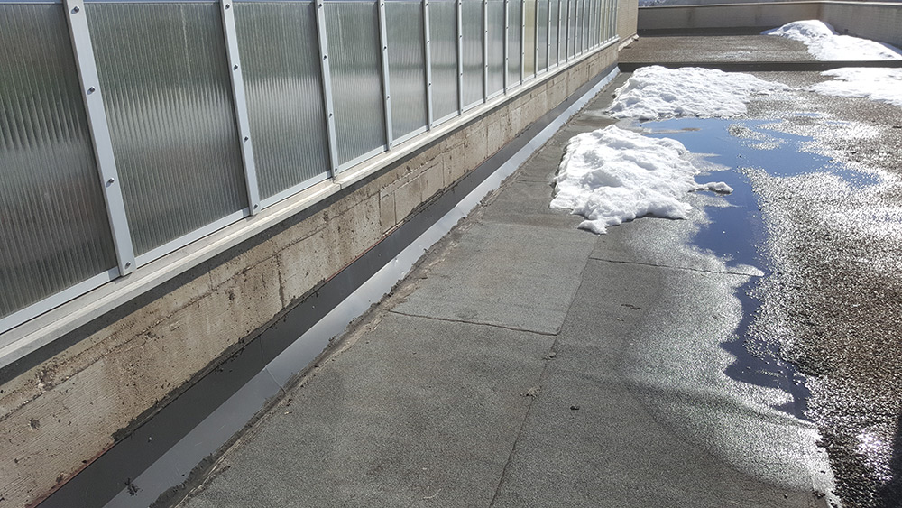 Roof surface showing existing wear before replacement